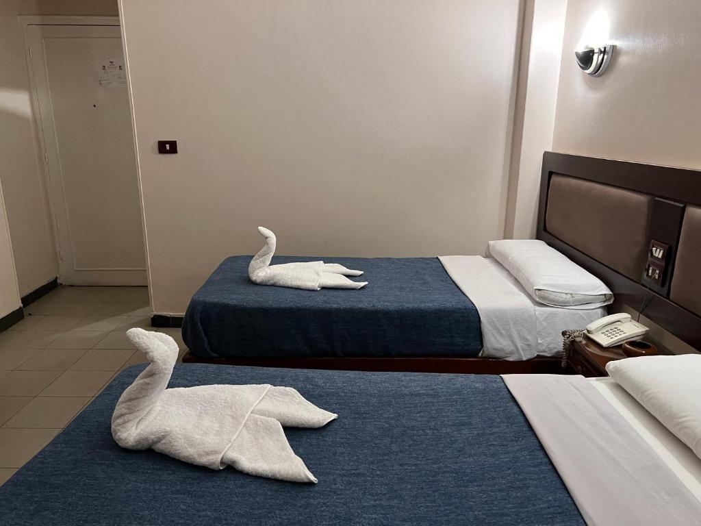 Postel nebo postele na pokoji v ubytování Anglo Hotel