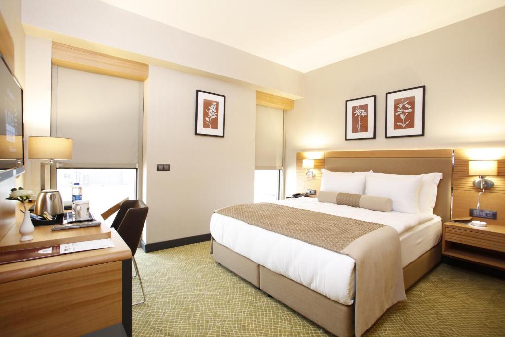 Postel nebo postele na pokoji v ubytování Mia City Hotel
