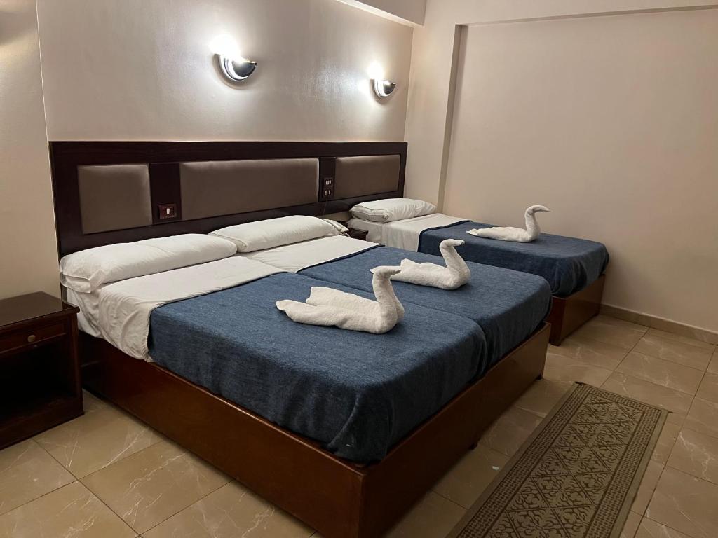 Postel nebo postele na pokoji v ubytování Anglo Hotel