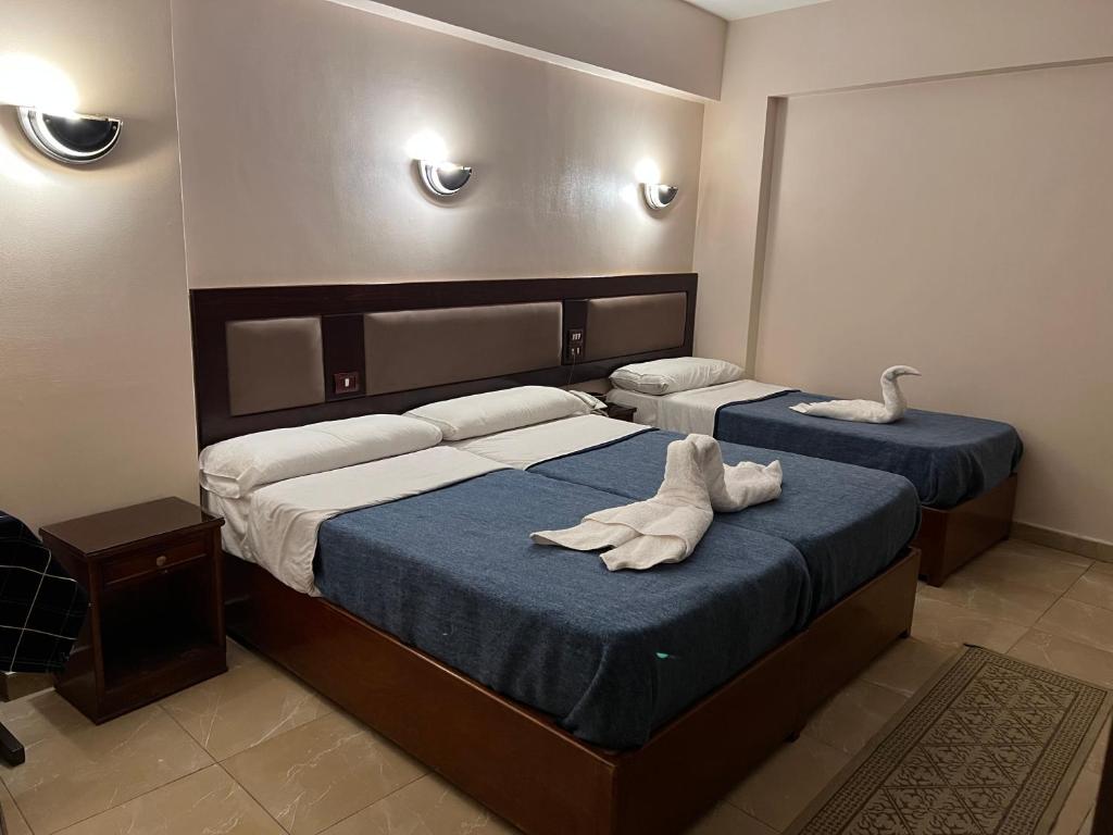 Postel nebo postele na pokoji v ubytování Anglo Hotel