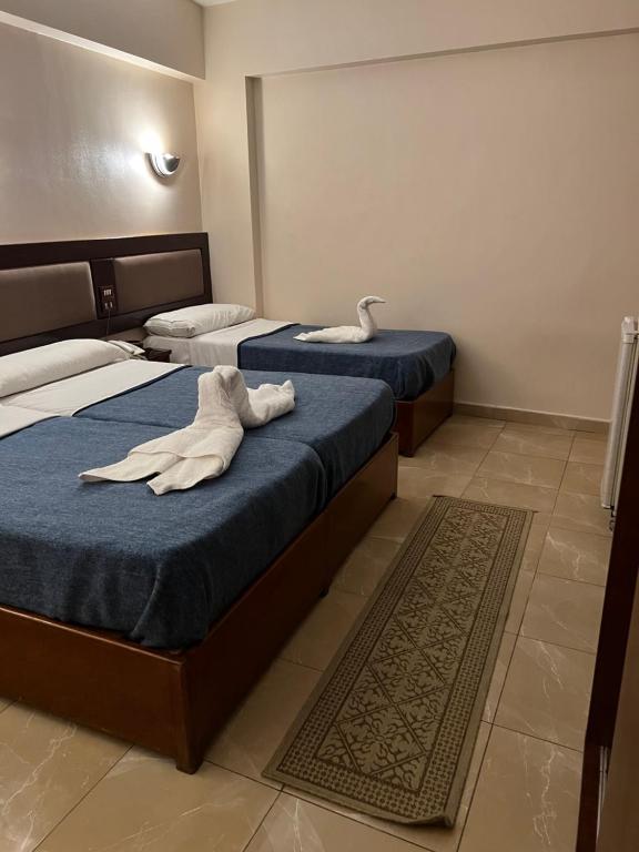 Postel nebo postele na pokoji v ubytování Anglo Hotel