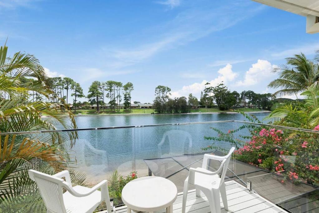 a balcony with a view of a swimming pool at Tranquil Oasis on Pine Lake in Gold Coast