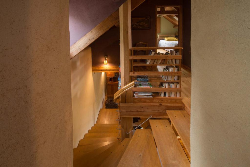 a hallway with wooden stairs in a house at MAISON YUKTI - Magnifique maison de charme proche plage in Lampaul-Ploudalmézeau