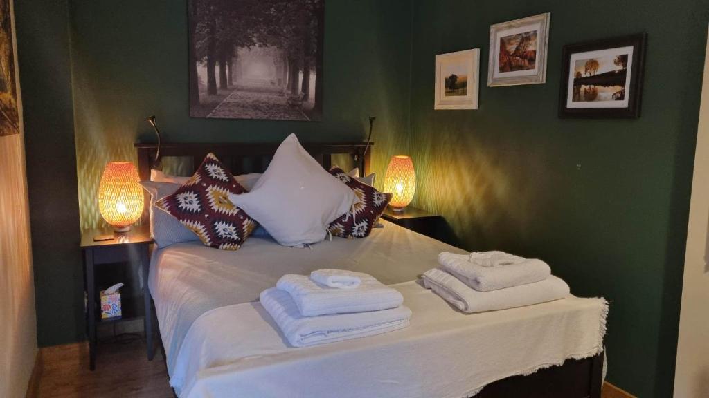 - une chambre avec un lit et des serviettes dans l'établissement The Orchards Guest Suite, à Willand