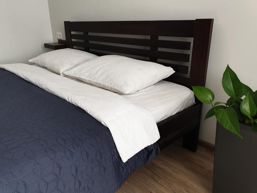 a bed with two pillows on top of it at New apartment 1 in Lviv