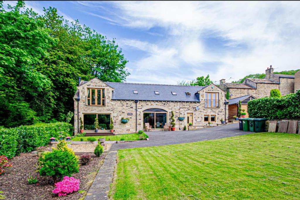 a large stone house with a yard at Bradley Manor, Cosy Retreat For Families & Friends in Huddersfield