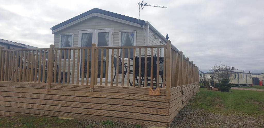 a tiny house on a wooden deck at 3 Bed New Lodge - 7 Lakes Country Park DN17 in Scunthorpe