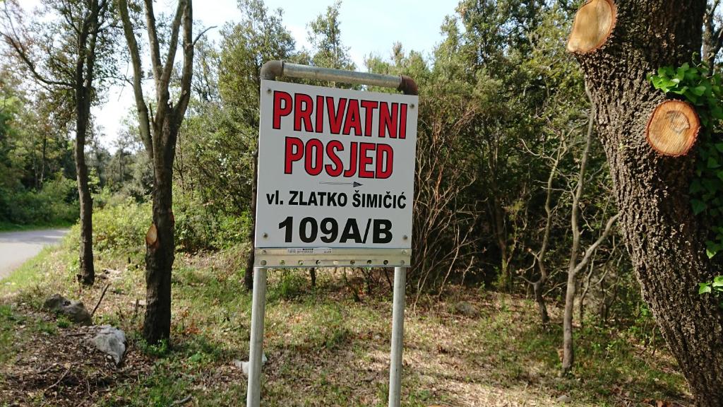 a sign is posted on the side of a road at House Forest&Beach Relax in Rab