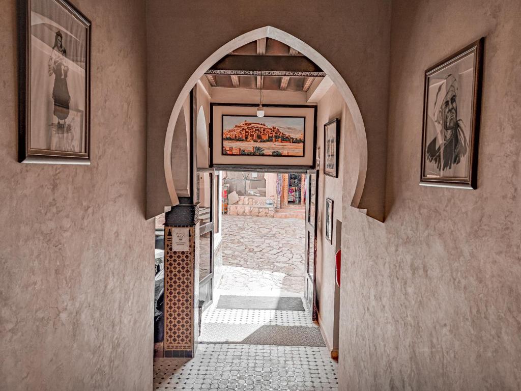 un pasillo con un arco en un edificio en Hôtel LAKASBAH Ait Ben Haddou, en Aït Ben Haddou