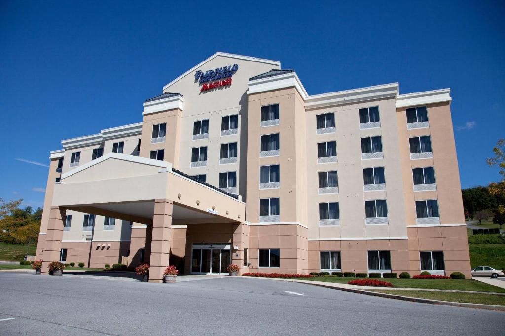 a large white building with a sign on it at Fairfield Inn & Suites Bedford in Bedford