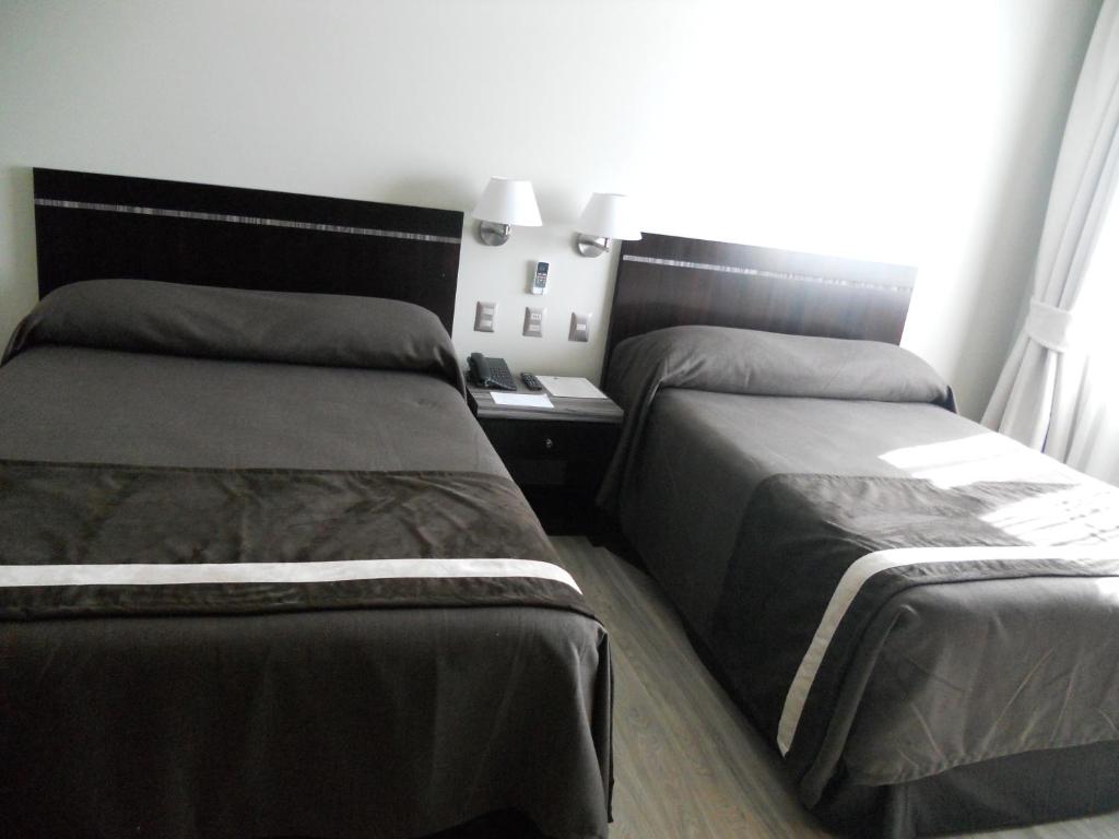 Una cama o camas en una habitación de Hotel Diego de Almagro Chillan