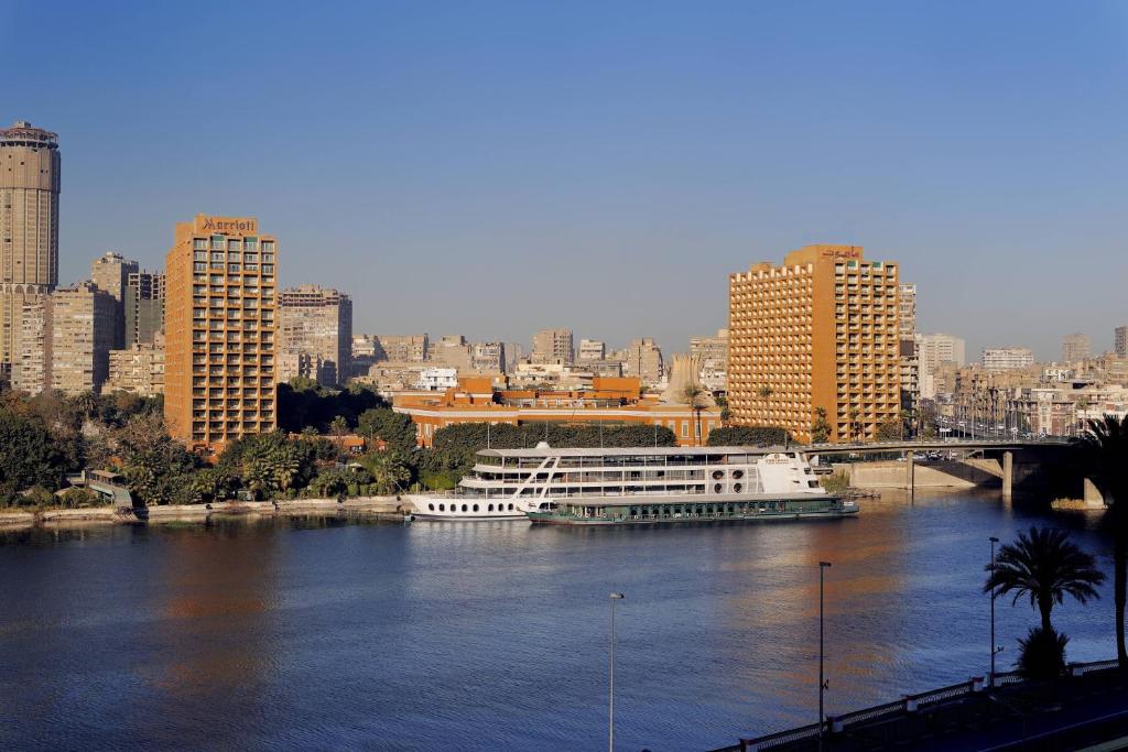 a large boat on a river in a city at Cairo Marriott Hotel & Omar Khayyam Casino in Cairo