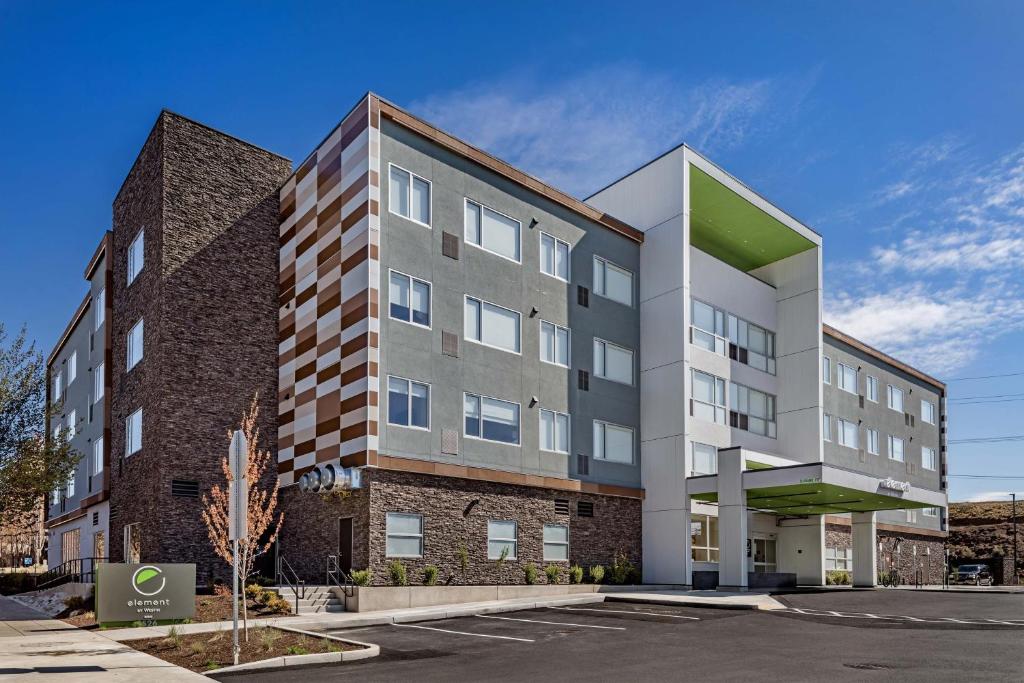 an apartment building in a parking lot at Element Bend in Bend