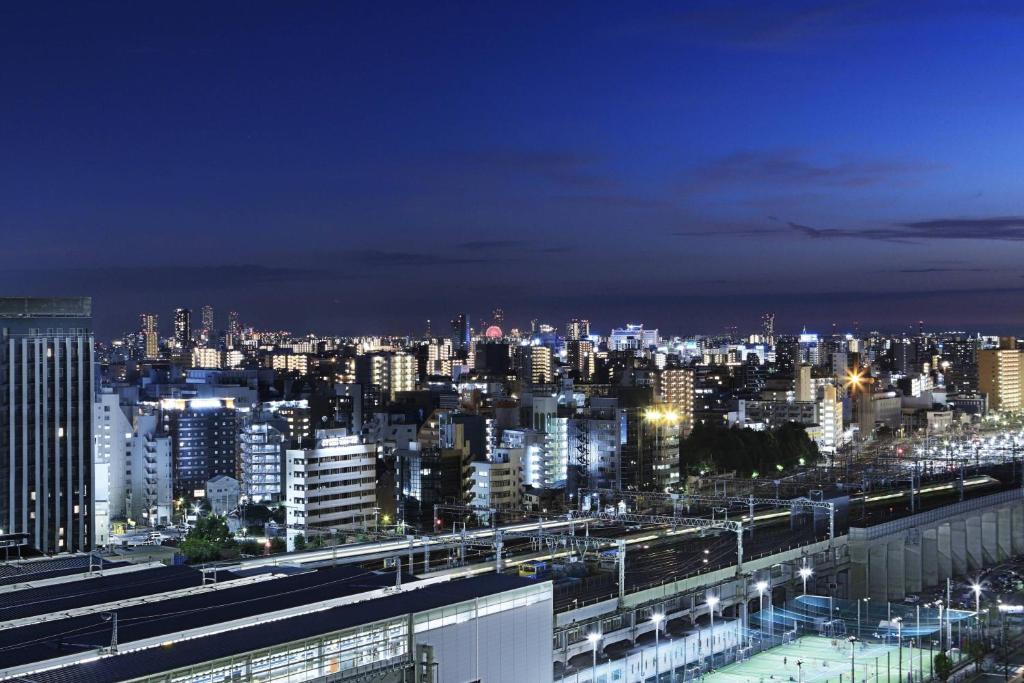 a view of a city at night with lights at Courtyard by Marriott Shin-Osaka Station in Osaka