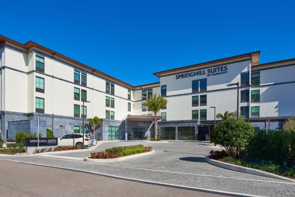 an exterior view of a hotel with a parking lot at SpringHill Suites by Marriott Winter Park in Orlando