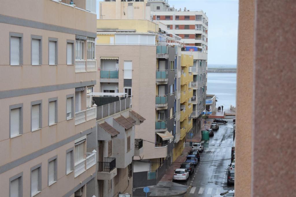 a view of a city street with tall buildings at Torri apartments - 3 mins walk to beach in Torrevieja
