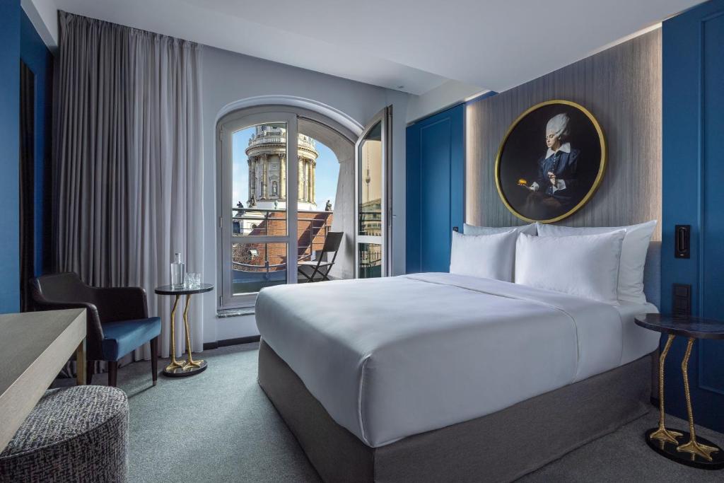 a hotel room with a bed and a window at Hotel Luc, Autograph Collection in Berlin