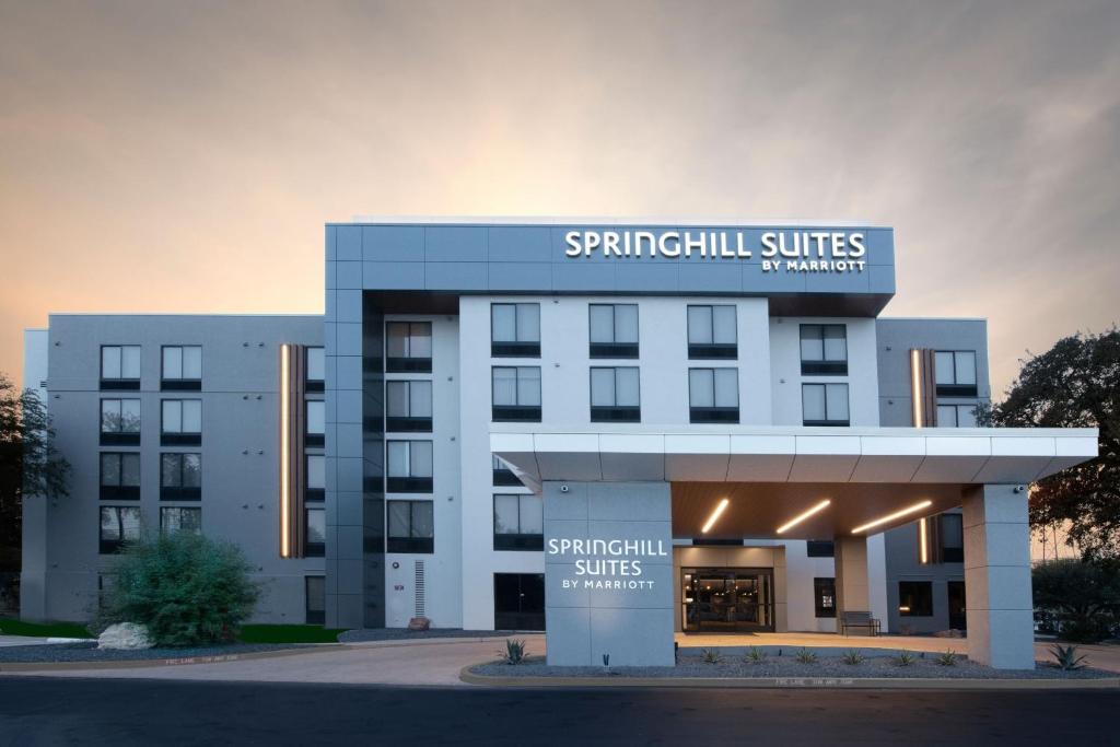 a building with a sign that reads spynilli suites at SpringHill Suites by Marriott Austin The Domain Area in Austin