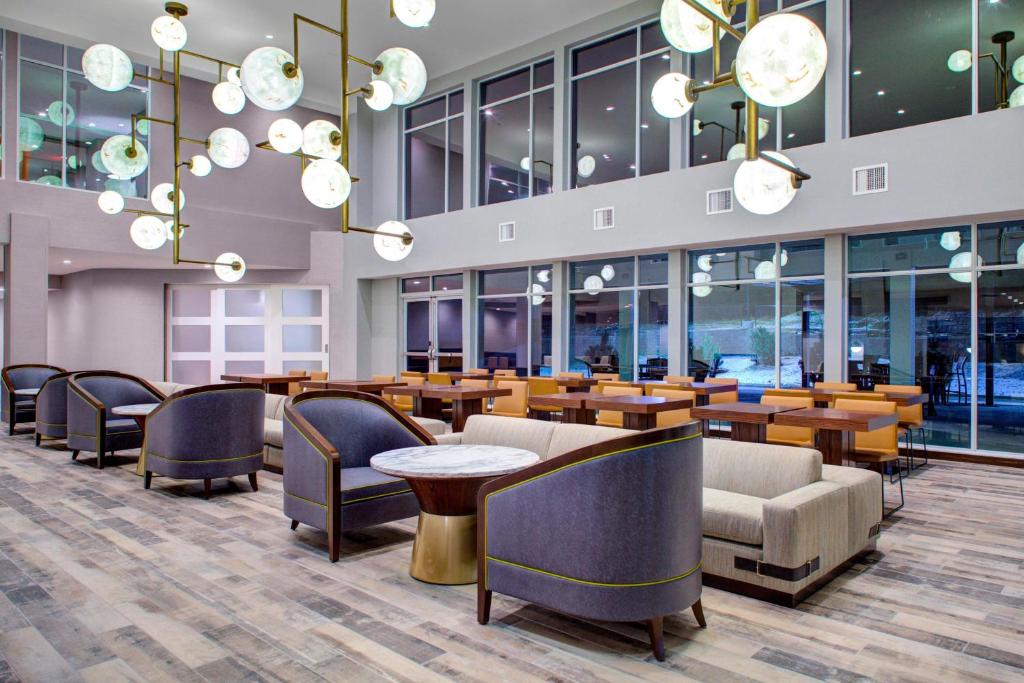 a lobby with tables and chairs and chandeliers at Residence Inn by Marriott Boulder Broomfield/Interlocken in Broomfield