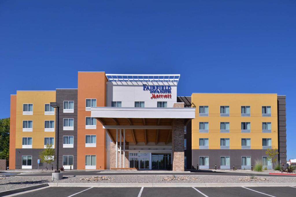 an empty parking lot in front of a hotel at Fairfield Inn & Suites Farmington in Farmington