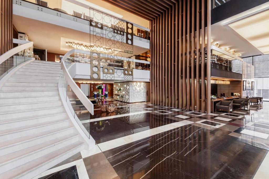 a lobby with a staircase in a building at Four Points by Sheraton Doha in Doha