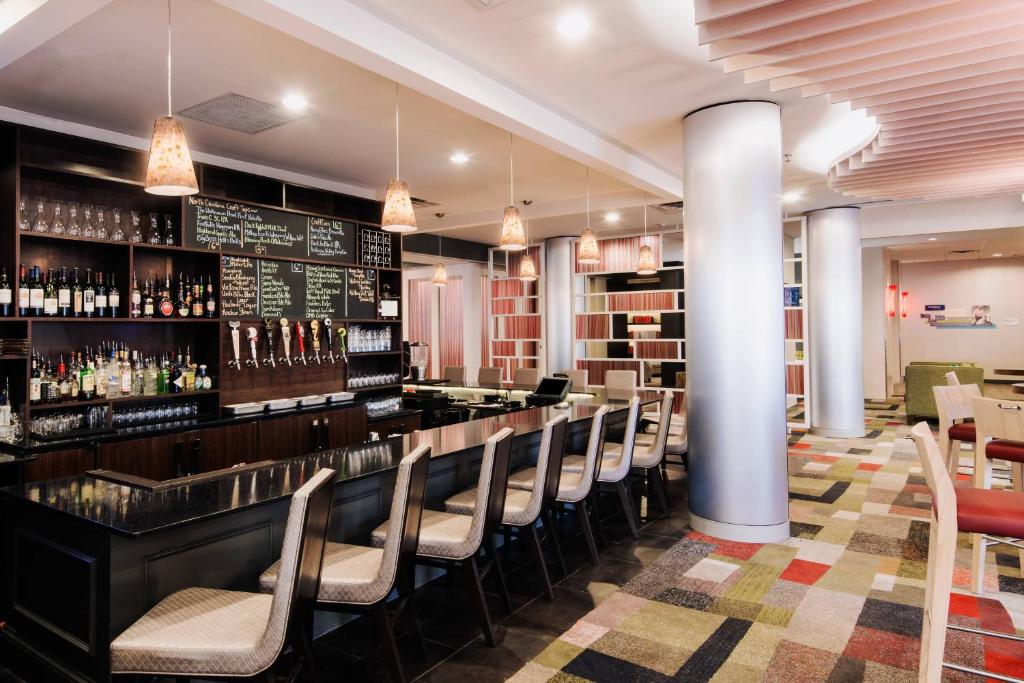 a bar in a restaurant with a row of chairs at Fairfield Inn & Suites by Marriott Charlotte Uptown in Charlotte