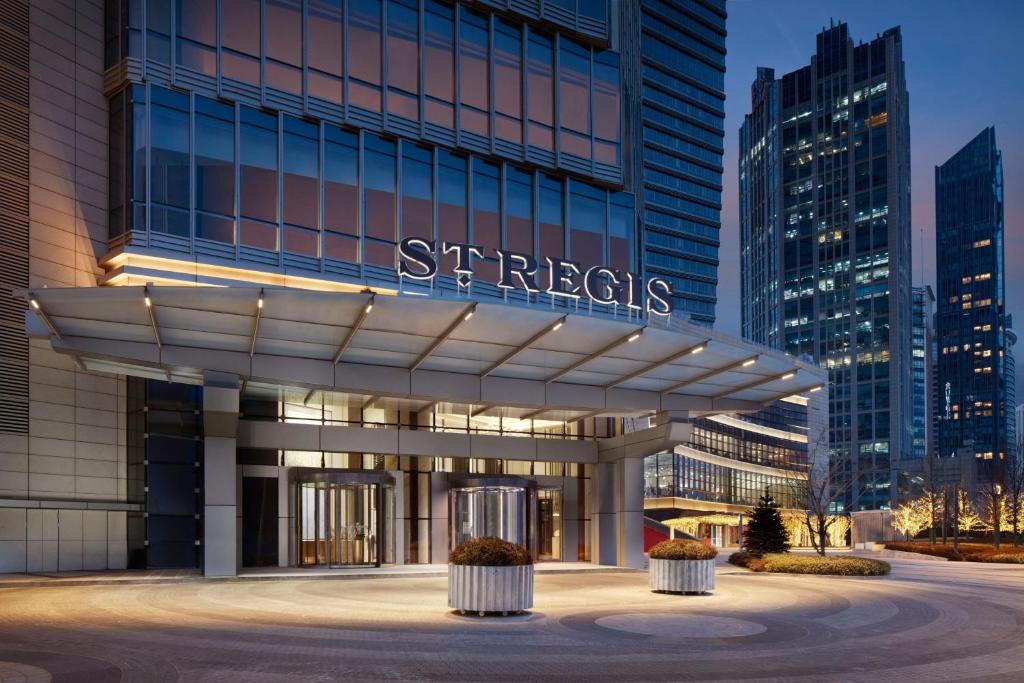 a building with a sign on the front of it at The St. Regis Qingdao in Qingdao