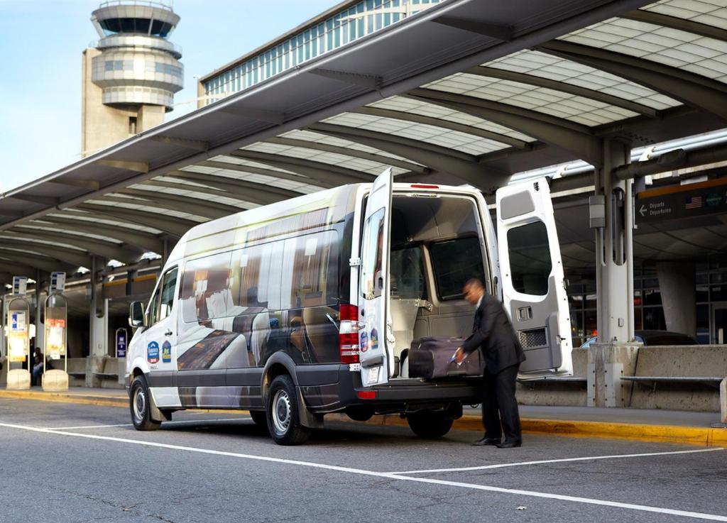 a man is standing in front of a bus at Fairfield Inn & Suites by Marriott Montreal Airport in Dorval