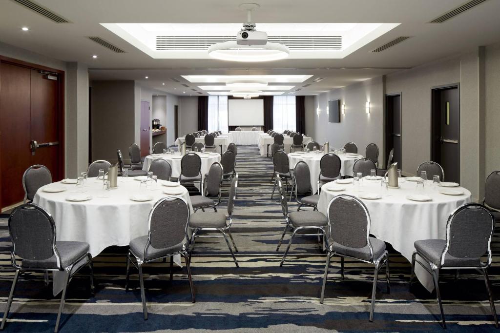 a conference room with white tables and chairs at Fairfield Inn & Suites by Marriott Montreal Airport in Dorval