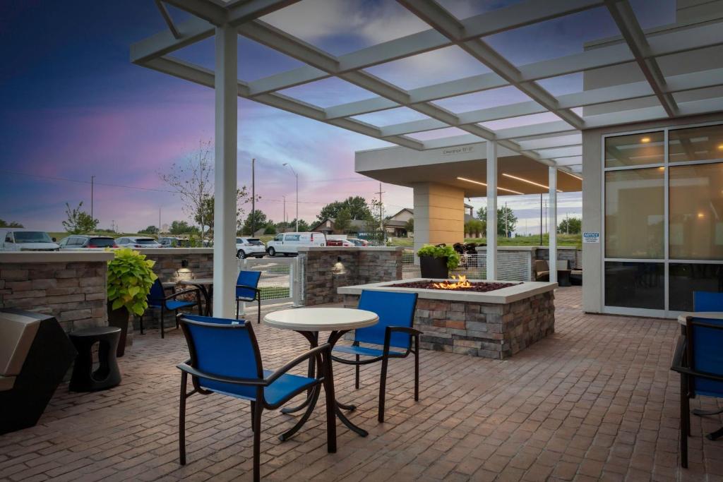 a patio with a table and chairs and a fire pit at SpringHill Suites Kansas City Airport in Kansas City