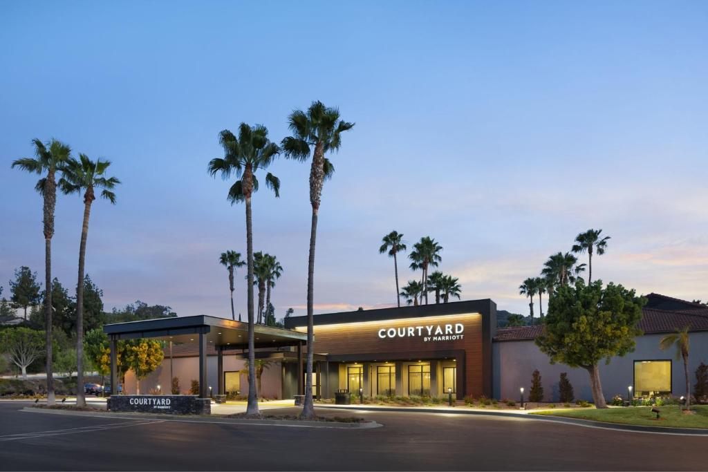 a court yard with palm trees in front of a building at Courtyard by Marriott Los Angeles Hacienda Heights Orange County in Hacienda Heights