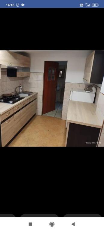 a kitchen with a sink and a counter top at Domek nad jeziorem in Ryn
