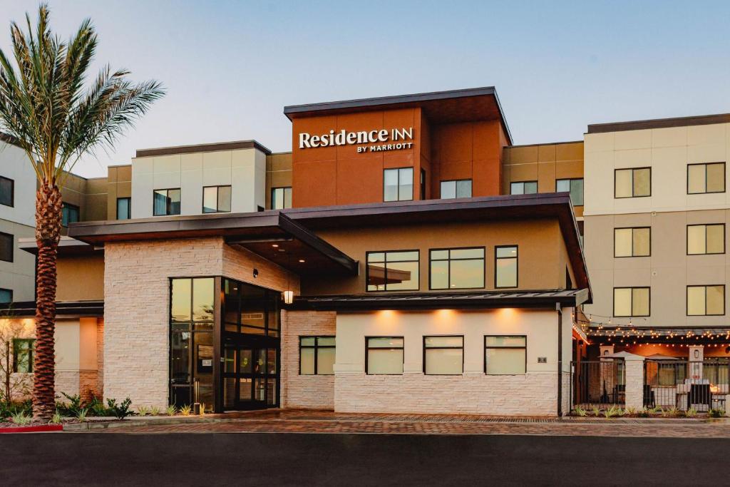 a building with a palm tree in front of it at Residence Inn by Marriott Loma Linda Redlands in Redlands