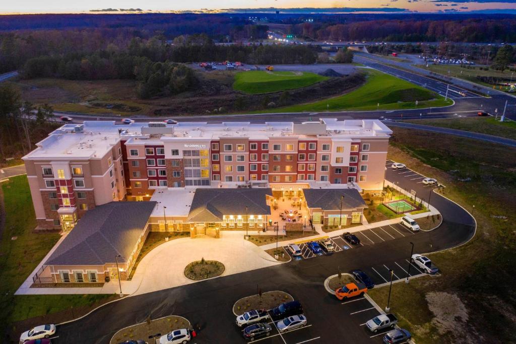an aerial view of a hotel with a parking lot at Residence Inn by Marriott Richmond at the Notch in Richmond