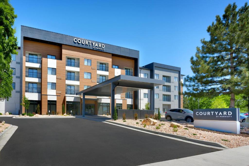 a building with a car parked in front of it at Courtyard by Marriott Salt Lake City Sandy in Sandy