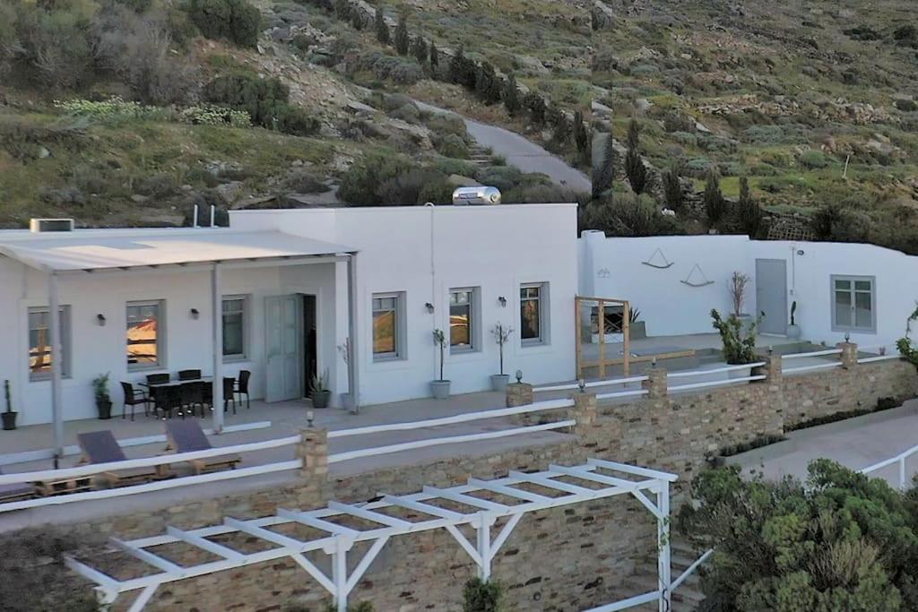 een wit huis bovenop een heuvel bij Κατοικία Uppolis με θέα τα νησιά in Ano Syros