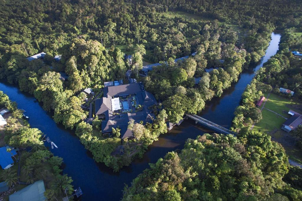 an aerial view of a house in the middle of a river at Mulu Marriott Resort in Mulu