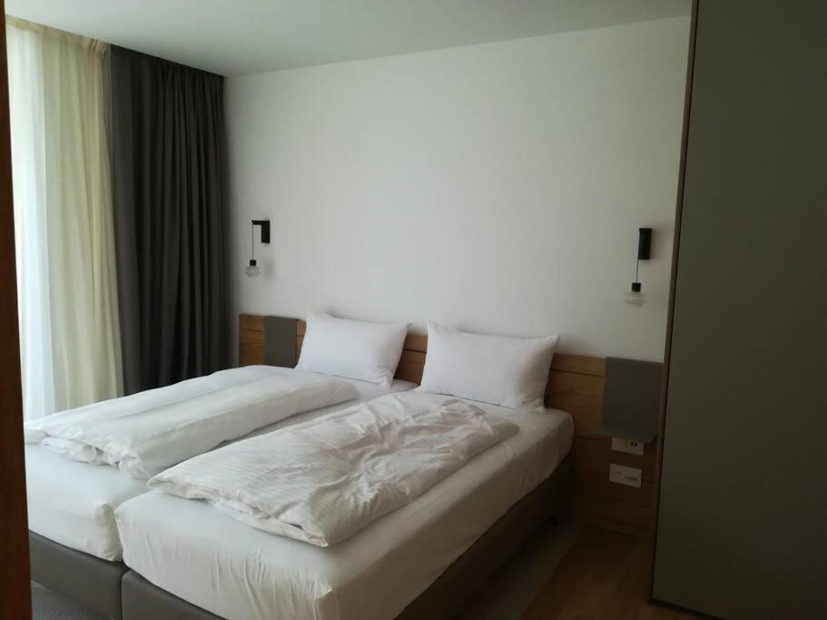 Postel nebo postele na pokoji v ubytování Gotthard Hotel Apartment