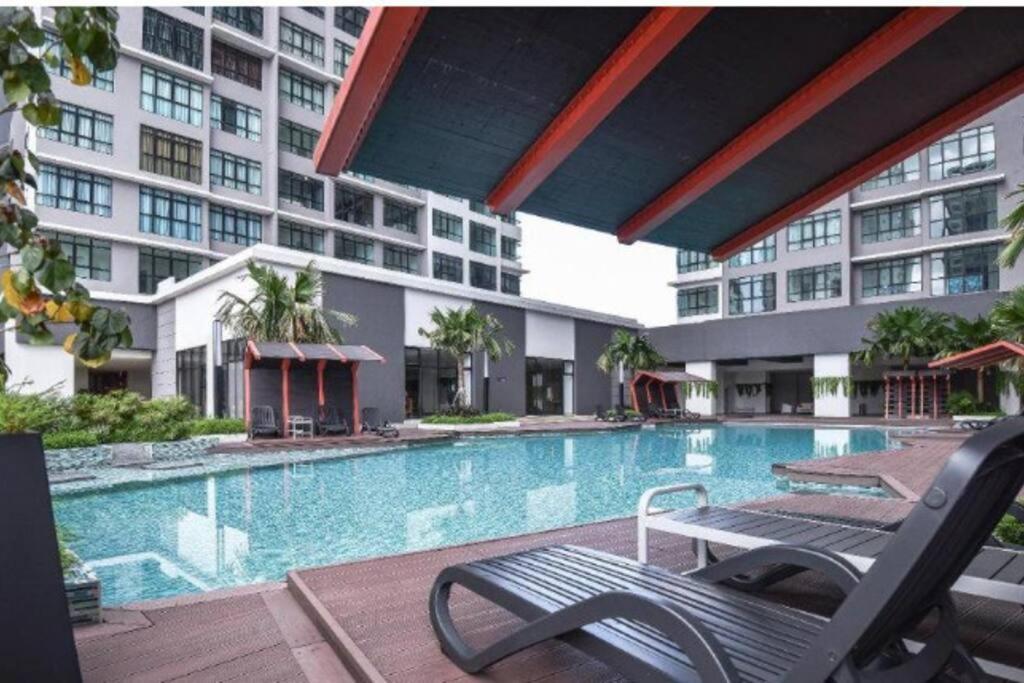 a swimming pool in front of a building at CheeAyu@ Putrajaya IOI Resort in Putrajaya