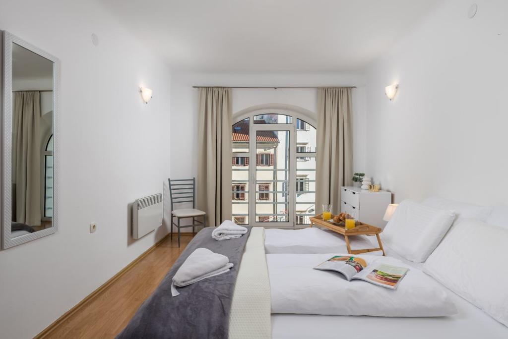 a living room with a white couch and a table at Main View Apartment in Rijeka