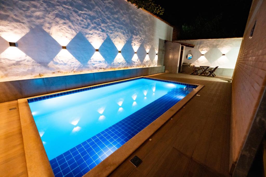 a swimming pool in a house with a lit up swimming poolvisor at Flats Oliveira in Pirenópolis