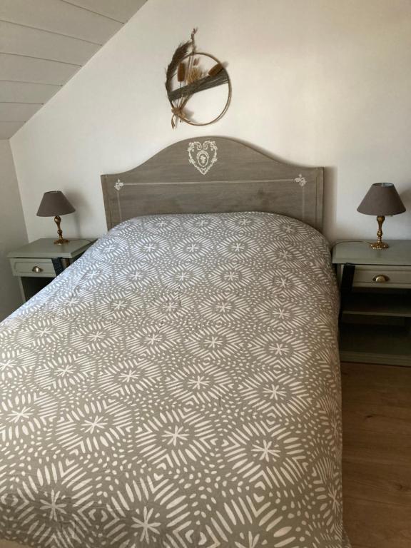 um quarto com uma cama grande e 2 mesas de cabeceira em Au passe temps em Beaucourt