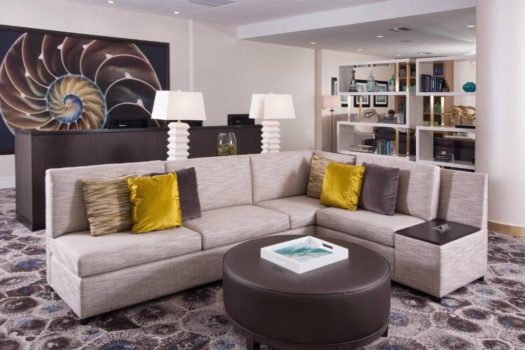a living room with a couch and a table at Courtyard Miami Coral Gables in Miami