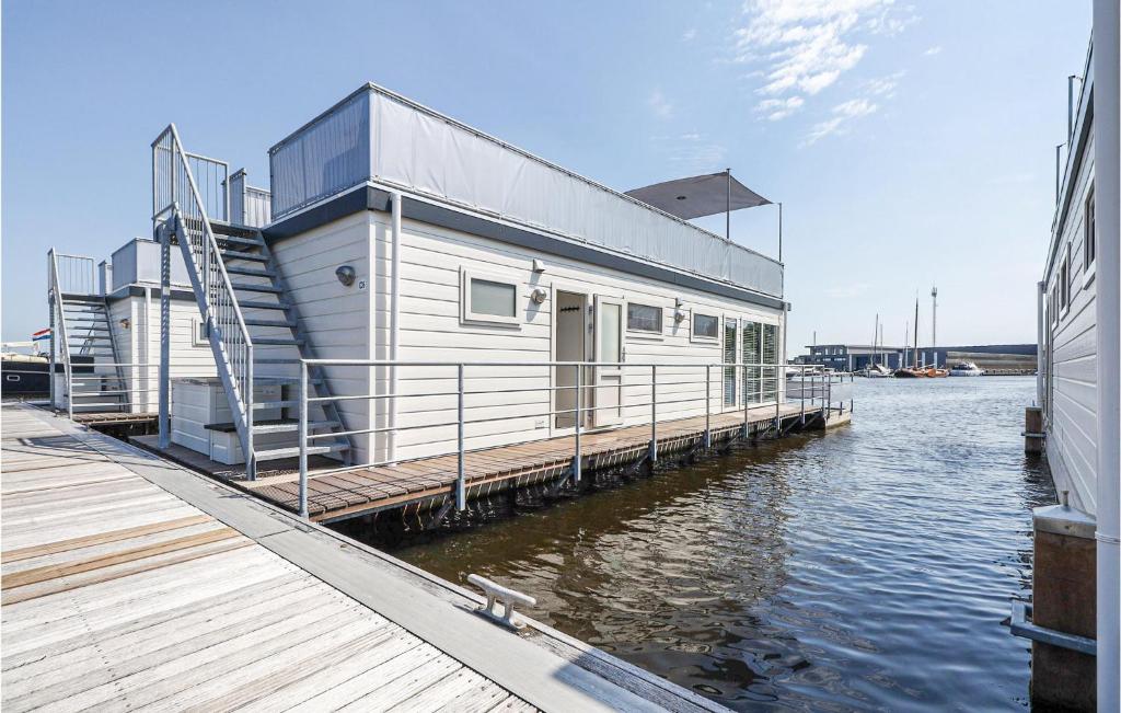 a house on a dock on a body of water at Aqualiving in Aalsmeer