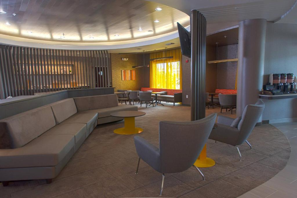 a lobby with a couch and chairs and tables at SpringHill Suites Houston Pearland in Pearland