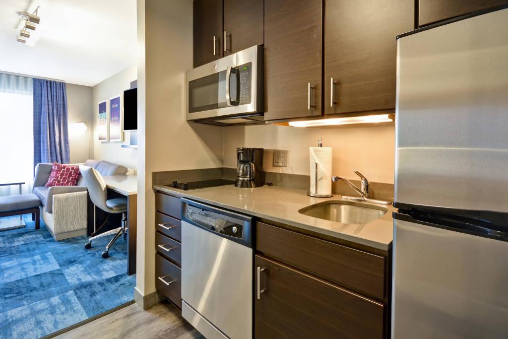 a kitchen with a sink and a counter top at TownePlace Suites by Marriott Dover Rockaway in Dover