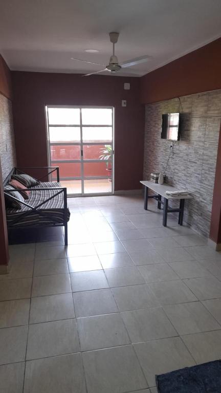 a room with a bed and a table and a window at Victoria apart in San Ramón de la Nueva Orán