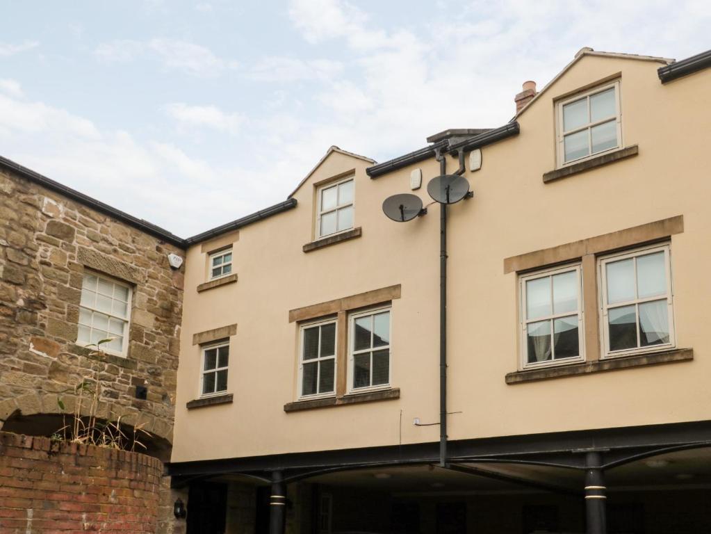 a building in front of a brick building at Lavenna in Alnwick