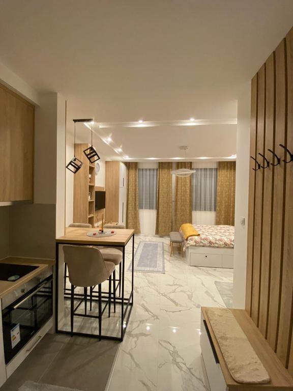 a room with a kitchen and a living room at Apartman Cristal LUX in Trebinje