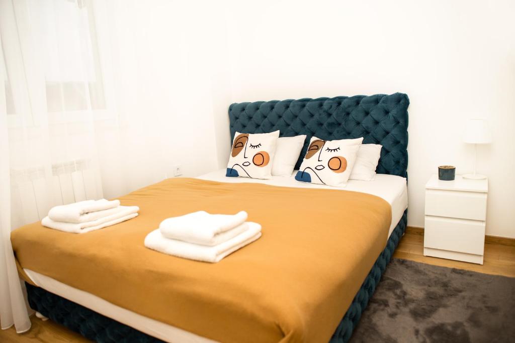 a bedroom with a bed with towels on it at Room21 FREE GARAGE in Novi Sad